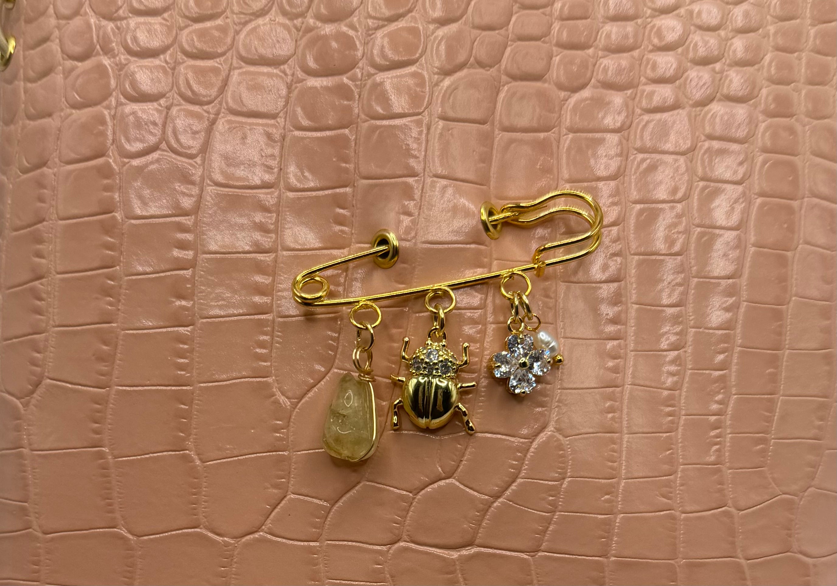 Soft blush A5 embossed with a subtle crocodile texture. Delicate gold charms and preserved nature.